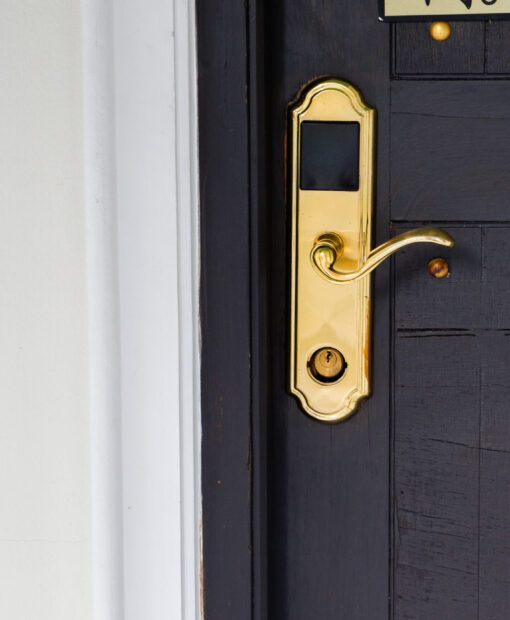 Close-up of wooden door with classic golden handles and ornaments,gold door handle and lock,Beautiful entrance to an expensive home or Luxury hotel,Copy space.